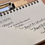 notepad with strategic procurement plan written in black pen